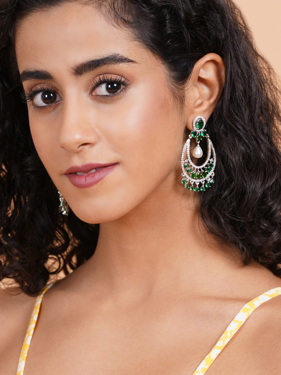 Green AD chandbali earrings with pearl drop, styled against green saree