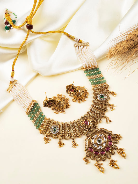 Antique gold Rajwadi necklace with asymmetric floral medallion and matching jhumkis