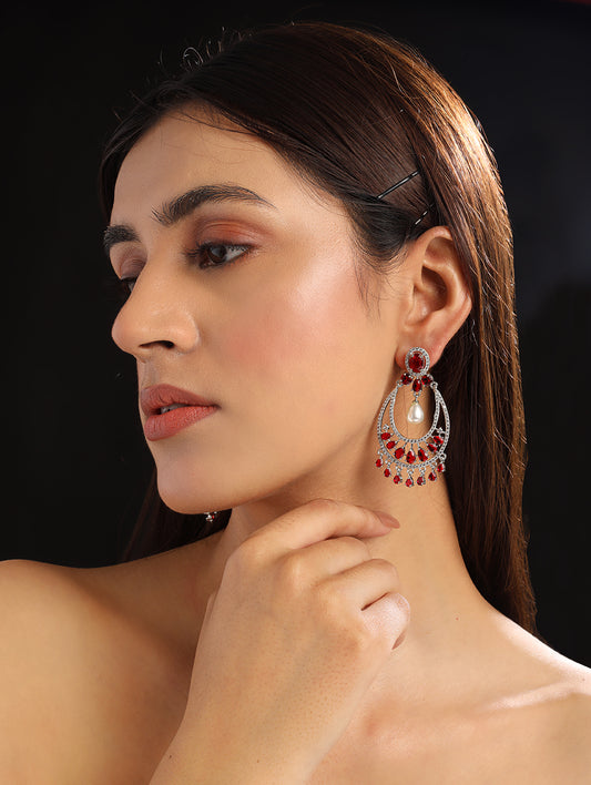 Woman wearing red AD chandbali earrings with pearl drop
