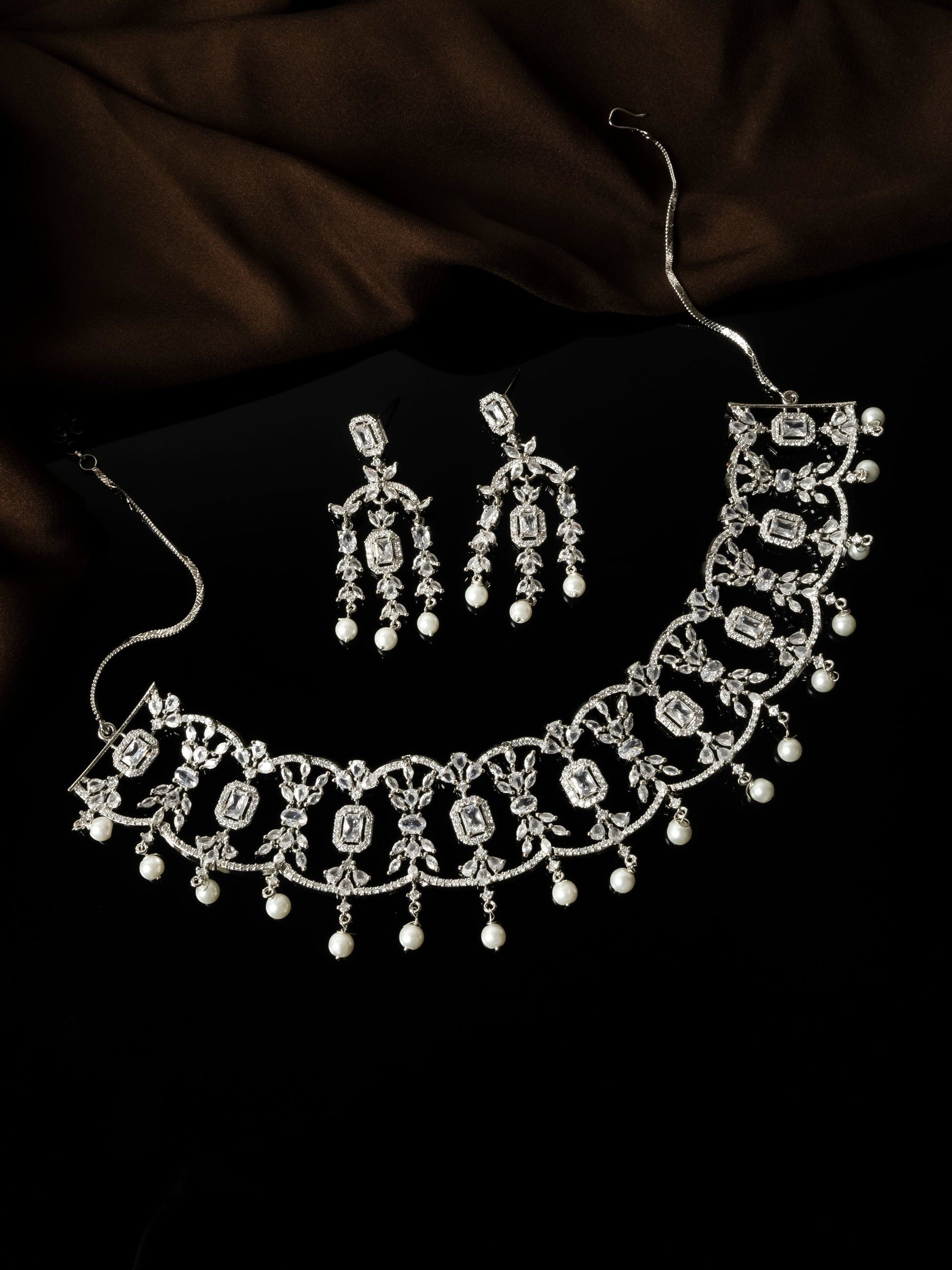 Close-up of emerald-cut CZ stones and floral vine detail on choker